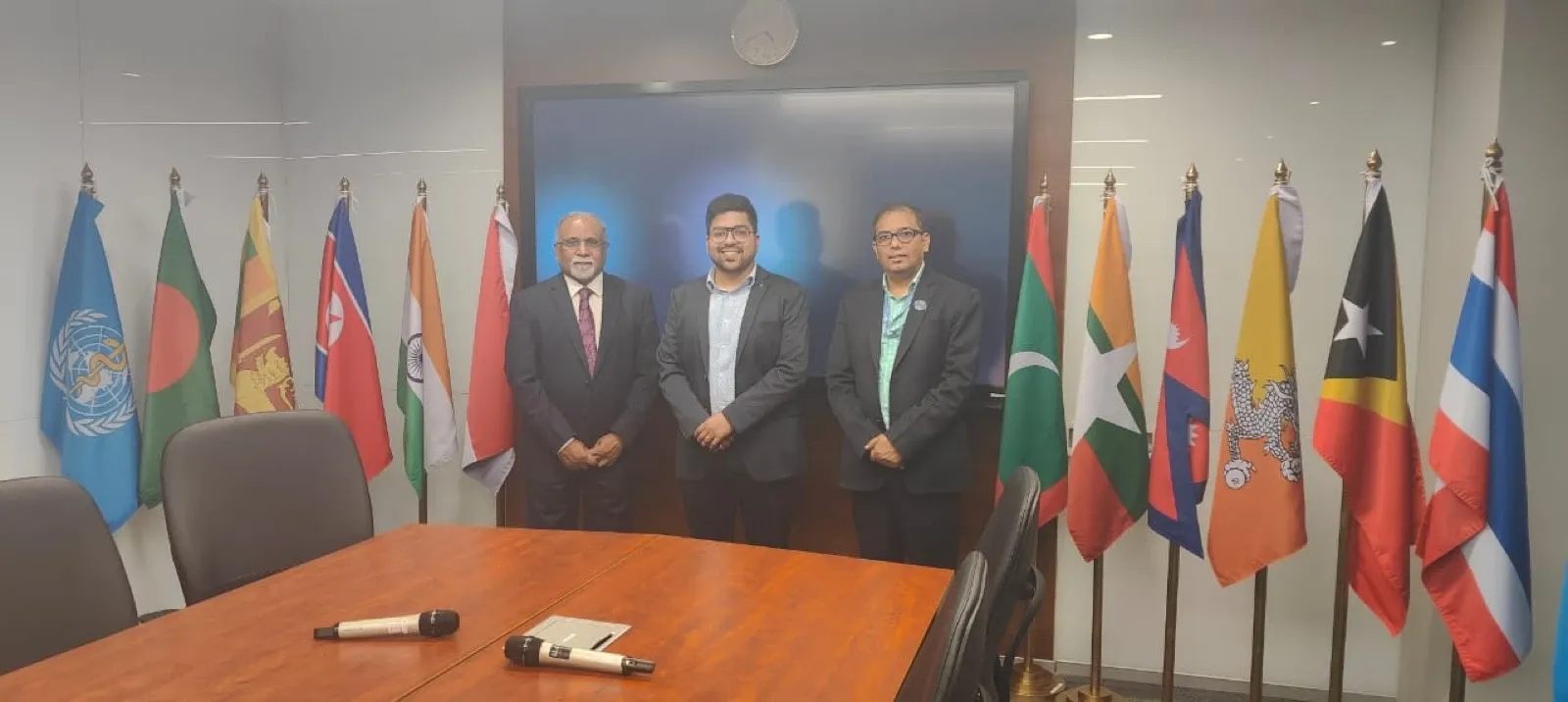 Clinics On Cloud leadership at an international meeting, member-nation flags behind them