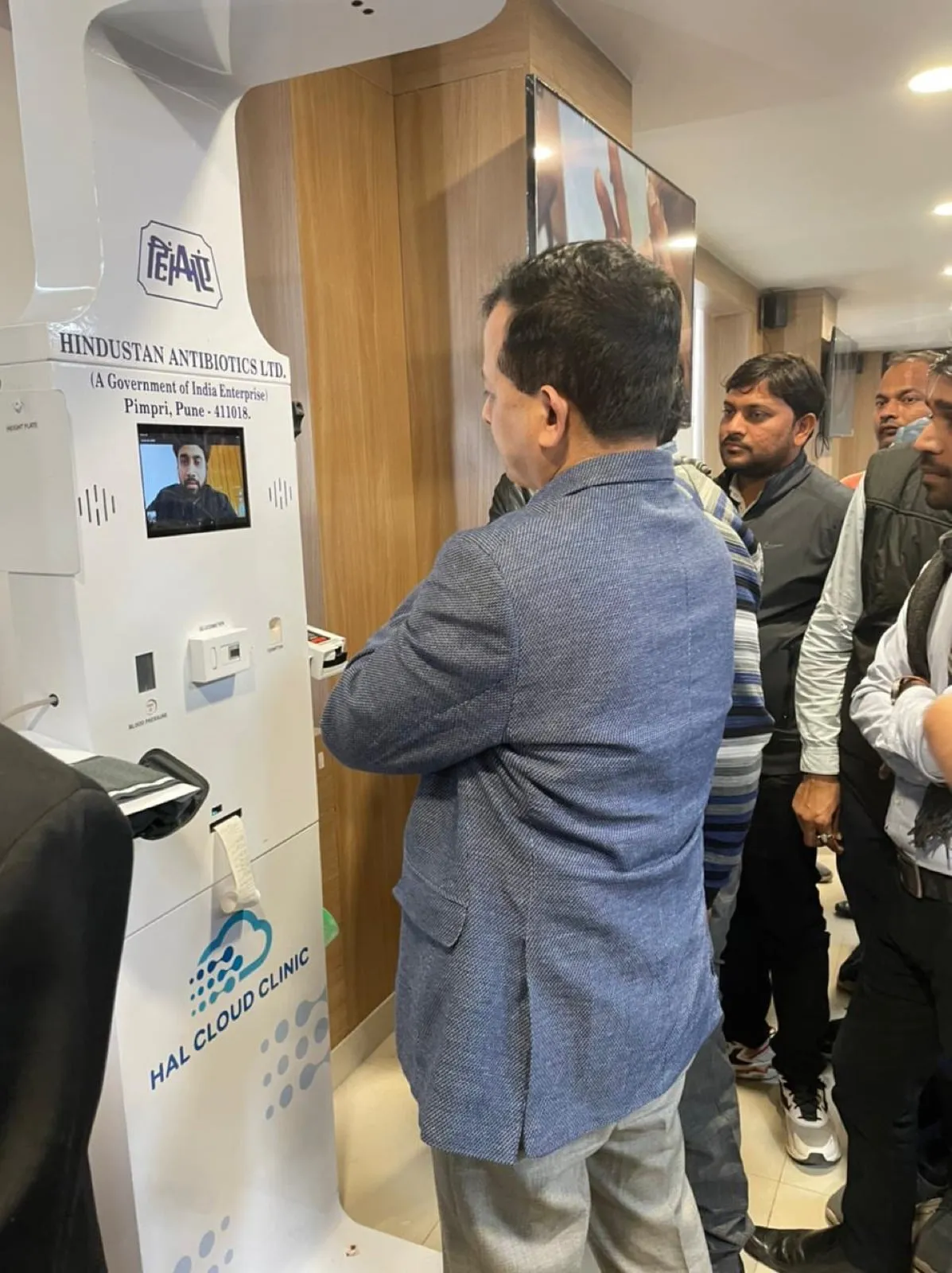 Officials trying the HAL Cloud Clinic health kiosk at a government demonstration