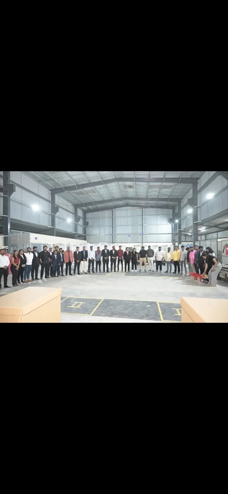 The full Clinics On Cloud team inside the expanded manufacturing hall