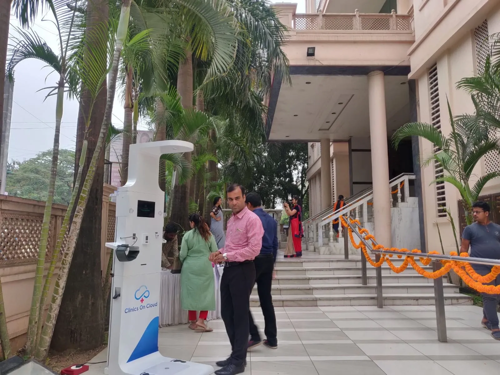 A Clinics On Cloud health kiosk installed and garlanded outside a client building